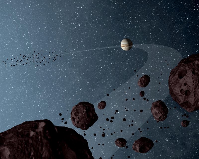 Fotograf: NASA/JPL-Caltech Konstnärlig tolkning av Jupiters trojanska asteroider. En grupp rör sig framför gasjätten och en grupp följer efter bakom. Illustration: NASA/JPL-Caltech. 